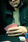Poker player studying cards