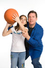 Father coaching daughter at basketball